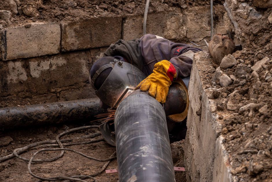 Close-up of a drainage pipe being repaired with relining equipment in a residential garden